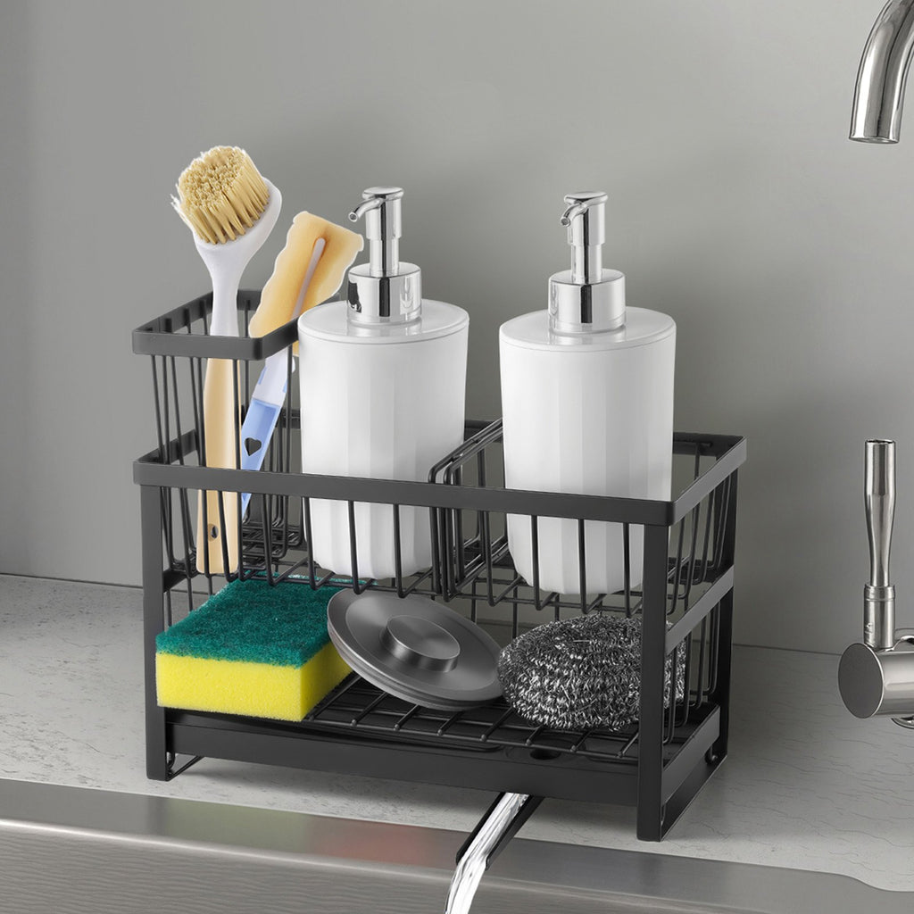 Black sink caddy beside a faucet holding brushes, sponges, scrubbers, and two pump bottles