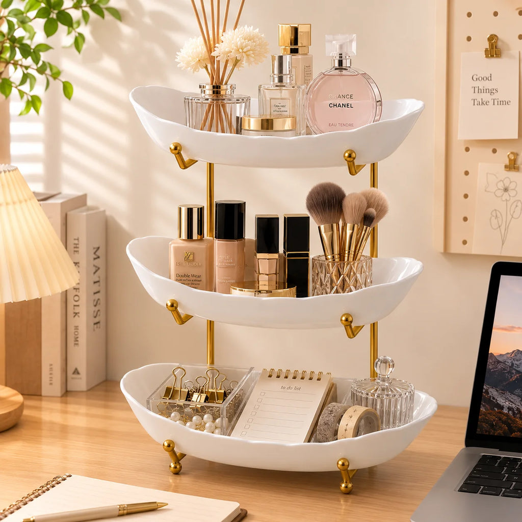 White tiered tray stand holding perfume, cosmetics, brushes, and small accessories