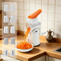 White manual rotary grater shredding a carrot with five cutting styles displayed