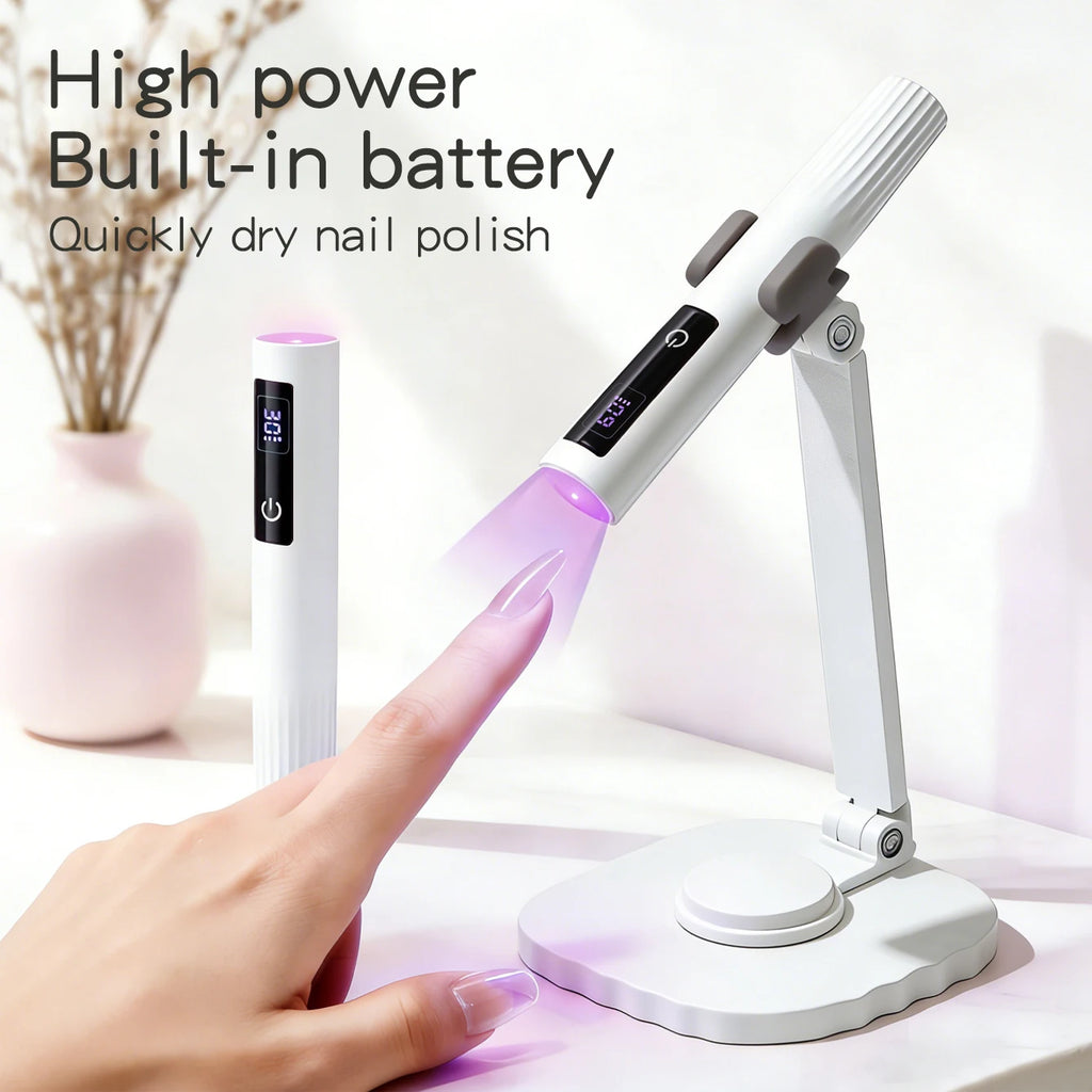 White handheld curing light in hand and mounted on tabletop stand