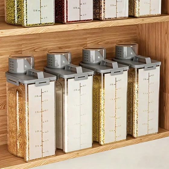 Four clear dry food storage containers with white trim displayed on a pantry shelf