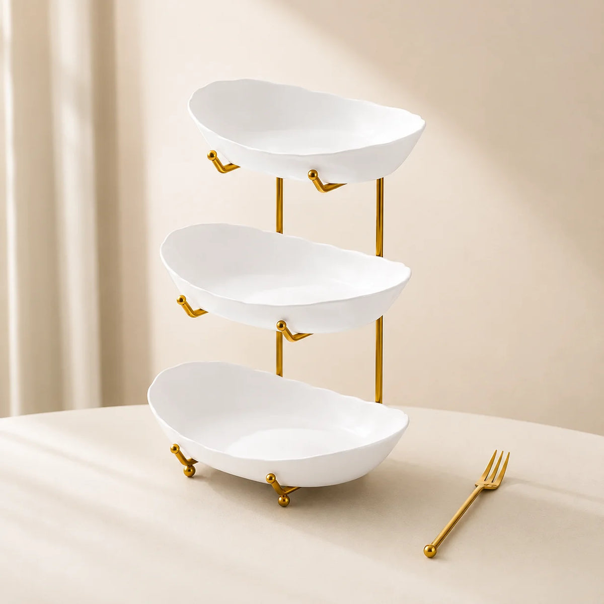 Empty white three-tier plastic bowl organizer with gold-tone frame