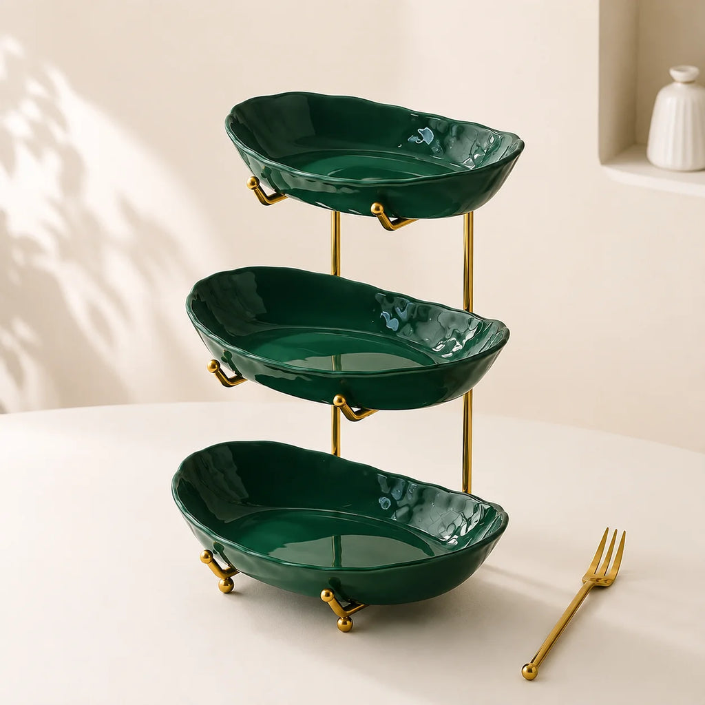 Empty green three-tier plastic bowl organizer with gold-tone frame
