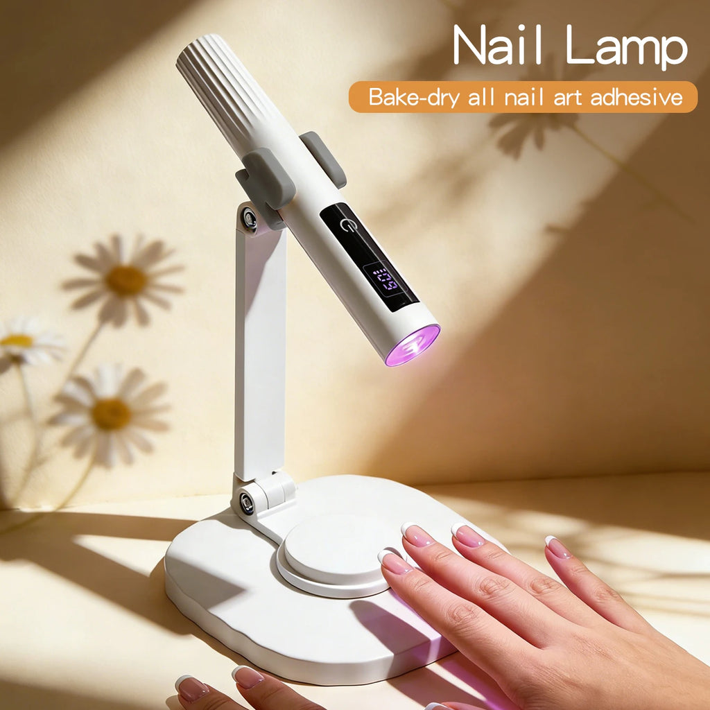 White stand-mounted nail lamp beside a manicured hand