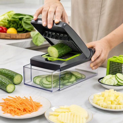 Manual vegetable slicer cutting cucumber into the clear collection container