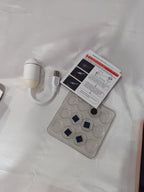 Compact white star projector lamp shown from an angle