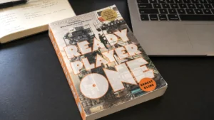book ready player one review on Zynqle with Ready Player One paperback on a reading desk